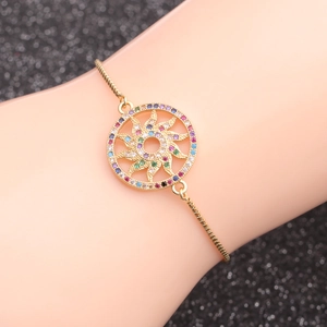 Adjustable gold sunburst bracelet with multicolored zircon stones on a black background