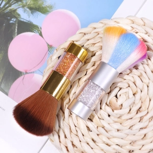 Colorful acrylic nail dust brushes with sparkling sequins in transparent handle on a mat
