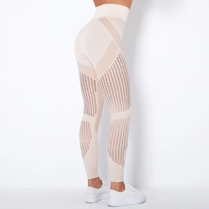 Detailed close-up of beige seamless yoga pants featuring vertical mesh cutout stripes