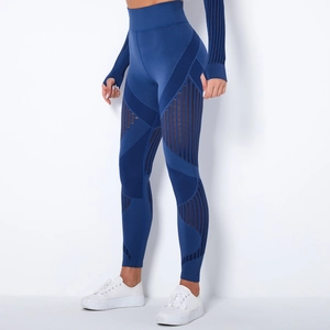 Detail showing seamless dark blue high-waisted yoga pants with side geometric mesh cutouts