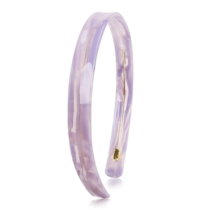 Detail of purple acetate headband with marble texture and golden metal trim strip