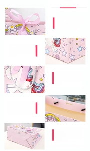 Pink unicorn gift bag featuring silk ribbon closure and silver braided handles detail