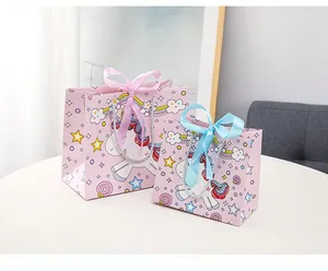 Detail of pink unicorn gift bags with satin bows and silver rope handles in two sizes