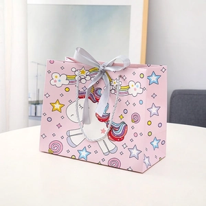 Pink unicorn cartoon gift bag with rainbow prints and a satin bow for children
