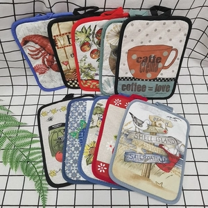 Detail of assorted quilted cotton hot pads with rustic prints and hanging loops