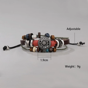 Detail of adjustable handmade leather bracelet with mixed beads and central metal charm