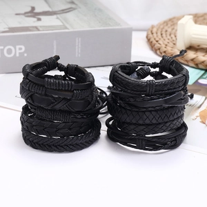 Retro multi-layer black braided leather bracelet set for men and women on white surface
