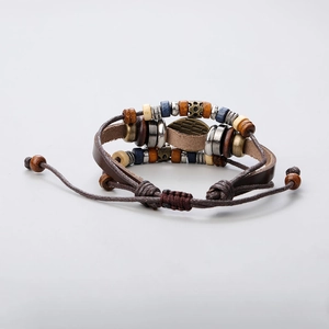 Close-up of multilayer leather bracelet featuring colorful beads and sunburst devil's eye