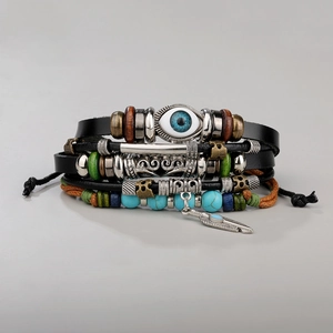 Detail of layered leather bracelet with turquoise beads and evil eye charm