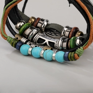 Detail view of multi-layer leather bracelet with turquoise beads and punk wood accents