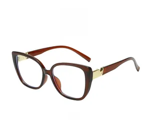 Detail of trendy square tea frames with a golden V emblem and clear lenses