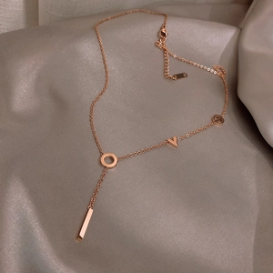 Rose gold LOVE letter Y-shaped titanium steel necklace on elegant champagne satin