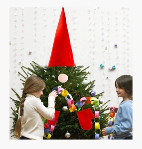 Kids decorating Christmas tree with a large red Santa hat topper and red glove ornaments