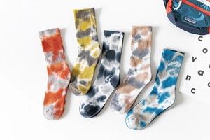 Flat lay view of five pairs of cotton tie-dye crew socks in various colorful patterns