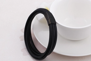 Detail of multi-layer black braided leather bracelet with matte black magnetic clasp