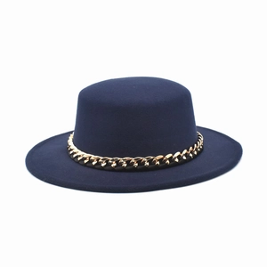 Detail of navy blue wool felt boater hat featuring a bold gold link chain decorative band