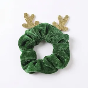 Christmas reindeer horn hair scrunchie in green velvet fabric with golden glitter accents