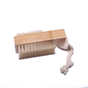 Detail of double-sided wooden nail brush with high density bristles and cotton lanyard
