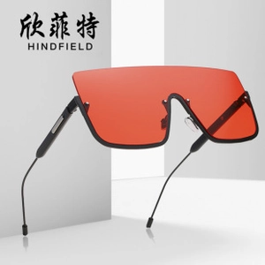 Detail of oversized orange square lenses with sleek black metal frame for sun protection
