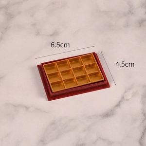 Miniature 12-slot gold display tray with red frame for dollhouse DIY crafts, 6.5x4.5cm