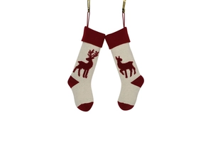 Detail of red and cream knitted Christmas stockings with reindeer patterns and hooks