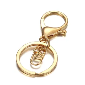 Close-up of a polished gold alloy keychain with swivel lobster clasp and flat key ring