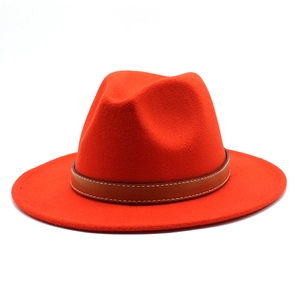 Detail of orange wool fedora hat featuring a brown leather band with white stitching