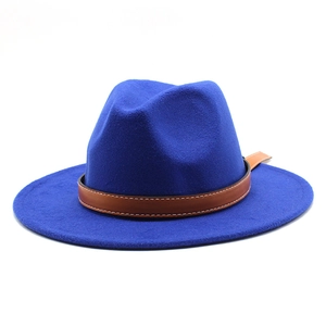 Close-up of royal blue wool fedora hat with brown leather decorative band detailing