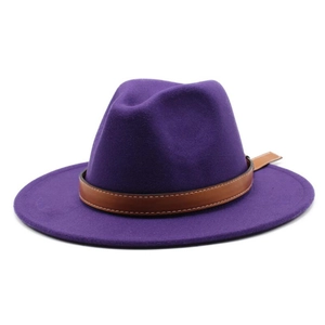 Detail of deep purple fedora hat featuring wide brim and brown leather band with stitching