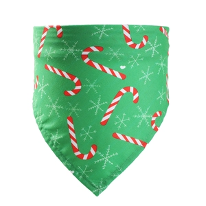 Detailed view of green Christmas pet bandana with candy cane and snowflake patterns