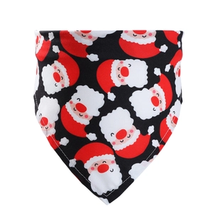 Detailed view of Christmas dog bandana with Santa Claus pattern on black cotton fabric