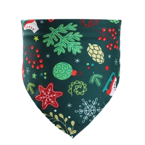Detail of dark green Christmas pet bandana with snowflake and pine cone festive patterns