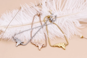 Detailed trio of religious icon bracelets in silver, gold, and rose gold with box chains