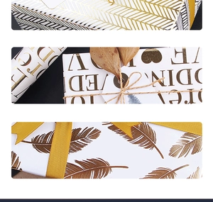 Close-up of premium gold foil geometric patterns and elegant text on white wrapping paper