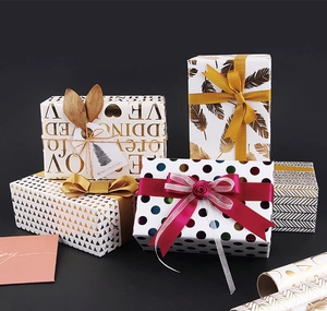Detail of luxury gold foil gift wrap patterns featuring hearts and geometric shapes