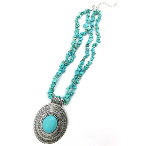 Bohemian silver necklace with turquoise gravel beads and large oval engraved pendant