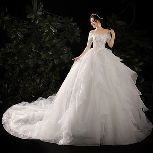Elegant off-shoulder wedding dress with lace bodice, tiered ruffled skirt and long train