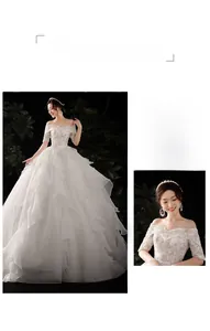 Detailed view of white off-shoulder wedding dress with delicate lace and sequin texture
