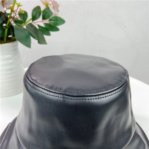 Chic black PU leather bucket hat featuring a textured finish and durable double stitching