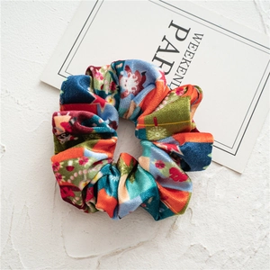 Macro detail of high-elastic velvet scrunchie with colorful festive holiday prints