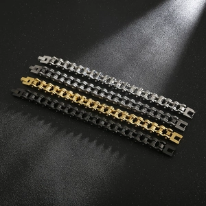 Detail of industrial motorcycle chain bracelets in silver, gold, and black finishes
