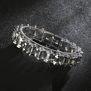 Macro shot of silver punk rhombic bike chain bracelet for men on black textured surface