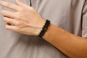 Industrial black stainless steel bicycle chain bracelet for men worn on a wrist