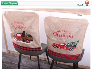 Detail of burlap Christmas chair covers featuring vintage red truck and festive dog print