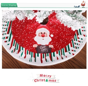 Detail of red Christmas tree skirt featuring Santa Claus with Warm Wishes and wavy borders