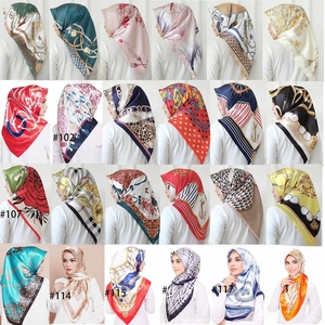 Collage of 24 satin silk headscarves featuring floral, leopard, and chain print patterns