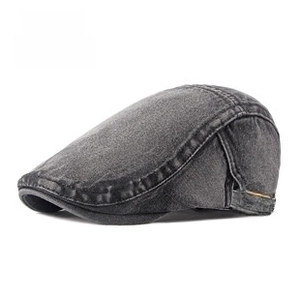 Detail of adjustable metal buckle and stitching on washed denim newsboy cap