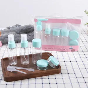 Travel set detail showing mint green spray bottles and jars in a clear zip pouch