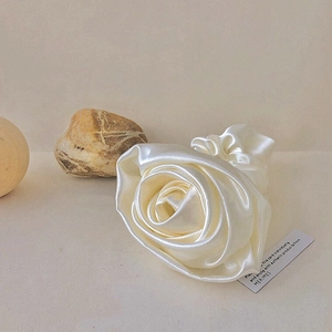 Elegant champagne rose hair scrunchie in satin silk fabric for a minimalist hair accessory look