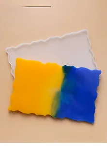 Macro detail of irregular wave silicone mold and yellow-blue gradient resin tray crafts